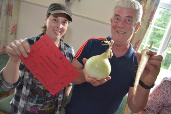 Hazel and her father Quentin Dickinson with a prize winning onion (Image: Lewis Clarke)